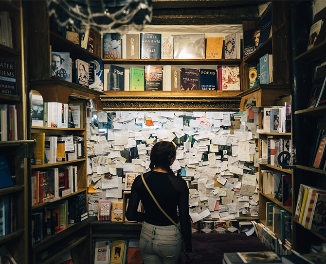 girl standing in a book library