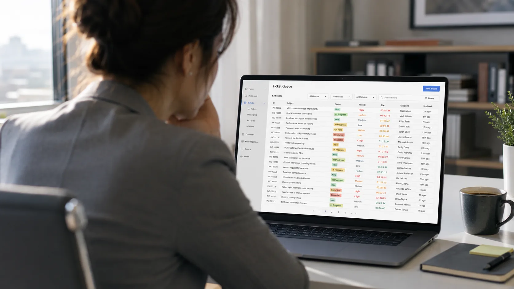 A VP at a laptop facing a service desk dashboard with dozens of open support tickets